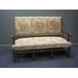 An 18th century style carved walnut country house sofa with tapestry panel upholstery on turned