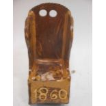 A treacle glazed pottery model of a lambing chair, bearing the date '1860', 20cm high