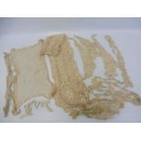 A good selection of lace and broderie anglaise including bonnets, a handkerchief, jacket, bag,