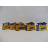 Five boxed Lesney Matchbox models including an E-Type Jaguar and an Aston martin DB2/4, all in