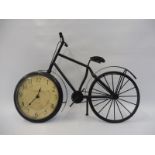 A decorative model bicycle with integral clock to the wheel.