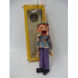 A boxed Pelham puppet 'Boy', cellophane box, open mouth version with original strings and