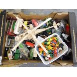 A box of die-cast models and an assortment of loose Playmobil.