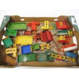 A box of farm implements and carts mainly Britains.