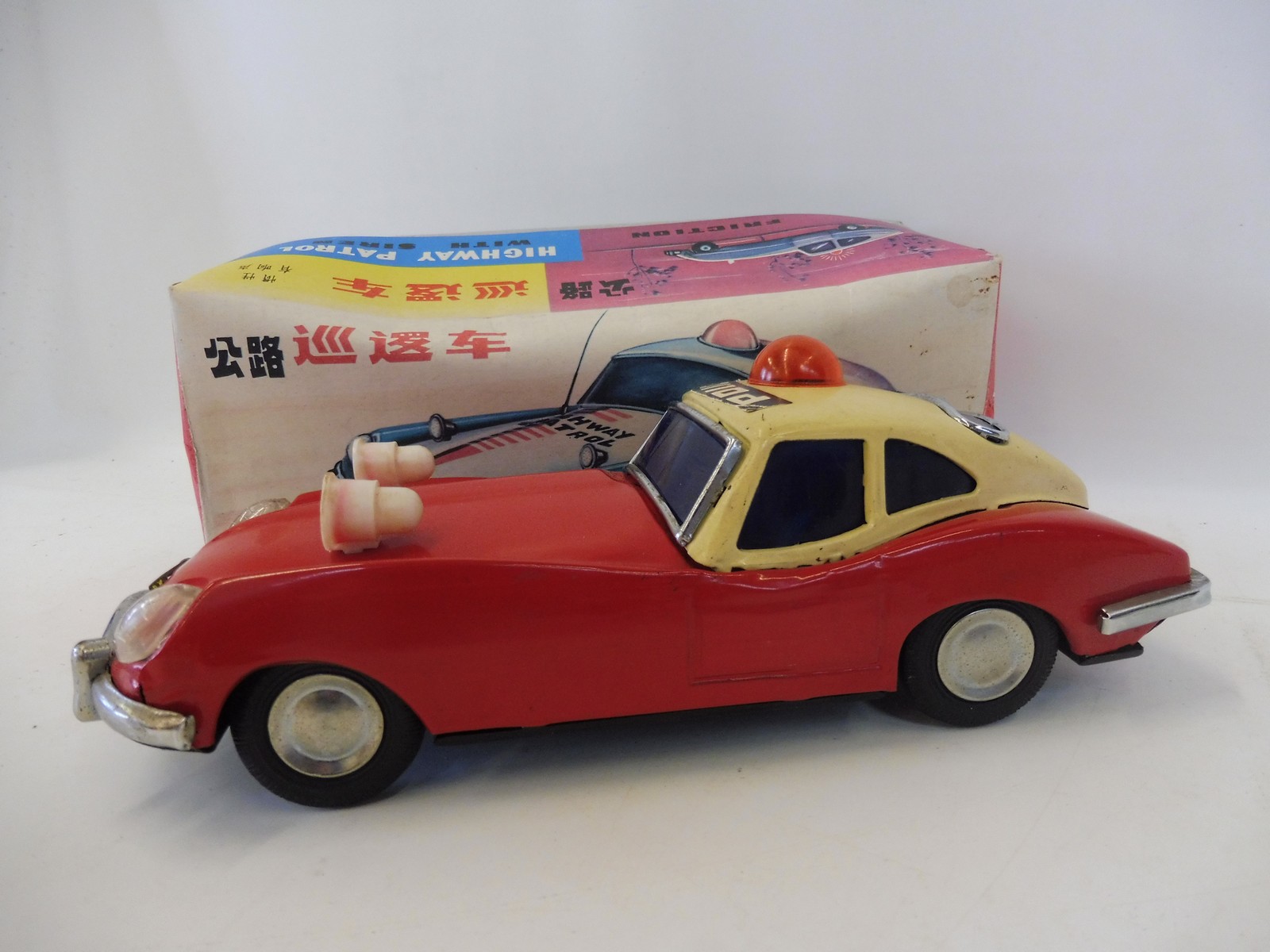 A boxed Chinese tinplate friction operated Highway Patrol Car with siren.