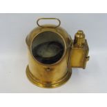 An unusual polished brass gimble compass with side paraffin burner to illuminate the dial, the