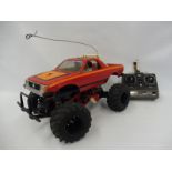 A Tamiya Subaru, 58038 electric Brat Monster Truck and controller.