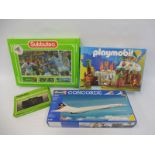 A Subbuteo table soccer game, a boxed Subbuteo Stadium Scoreboard, a Playmobil no. 3040 and a Revell
