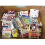 A box of assorted carded models, all appear to be emergency vehicle related including Siku, Ertl