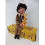 A boxed Pelham puppet 'Saxophone Player', late 1960s in non-original box in very good condition,