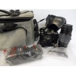 A Minolta camera with accessories, lever etc. in a bag.