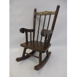 A miniature wooden rocking chair, ideal for dolls or teddies to display.