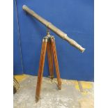 A contemporary telescope on a tripod stand.