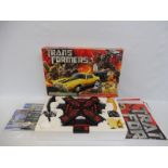 A boxed Micro Scalextric Transformers electric micro slot racing set 1:64.