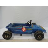 A 1970s plastic pedal car in the form of a Formula 1 racing car with Raleigh decals.