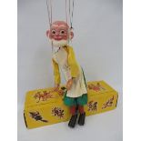 A boxed Pelham puppet 'Gepetto', mid to late 1960s, bald version with original strings, controller