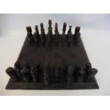 A wooden chess set on a well veneered board.