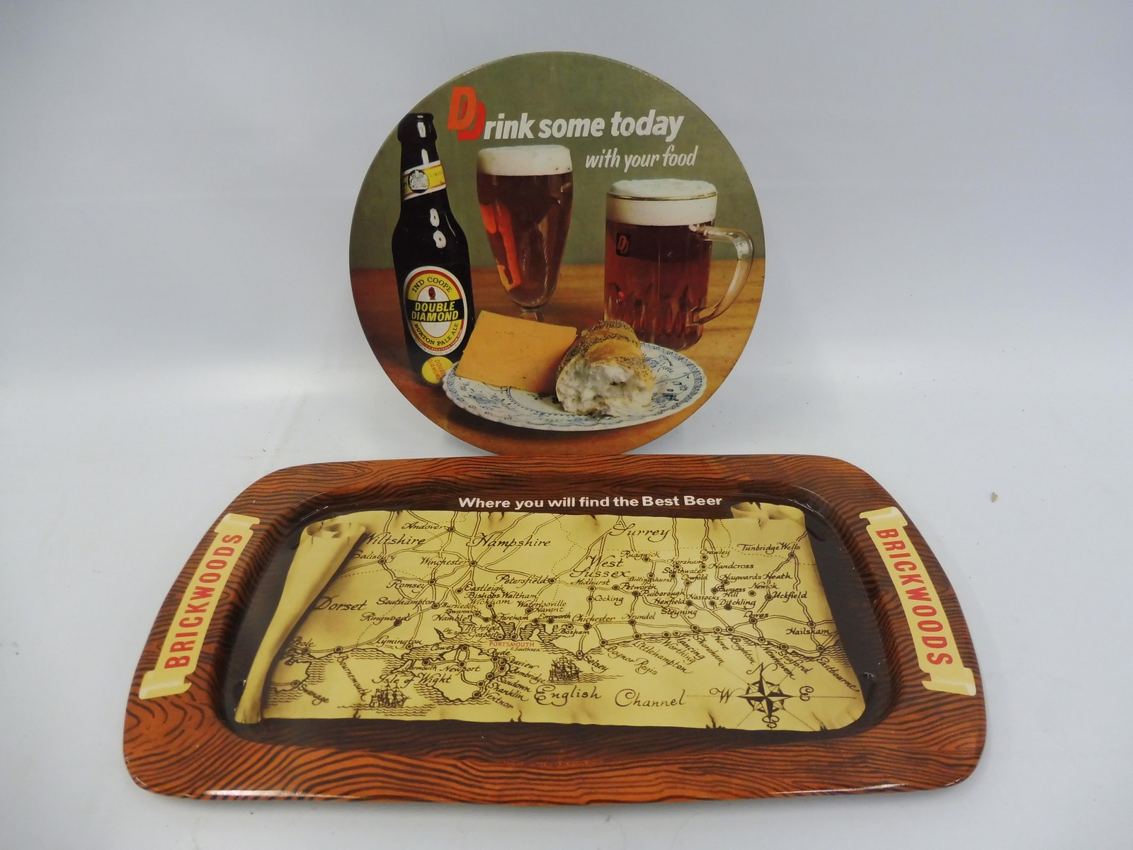 A Double Diamond pictorial showcard, 8 1/2" diameter plus a Brickwoods beer tray, 14 1/2 x 8".