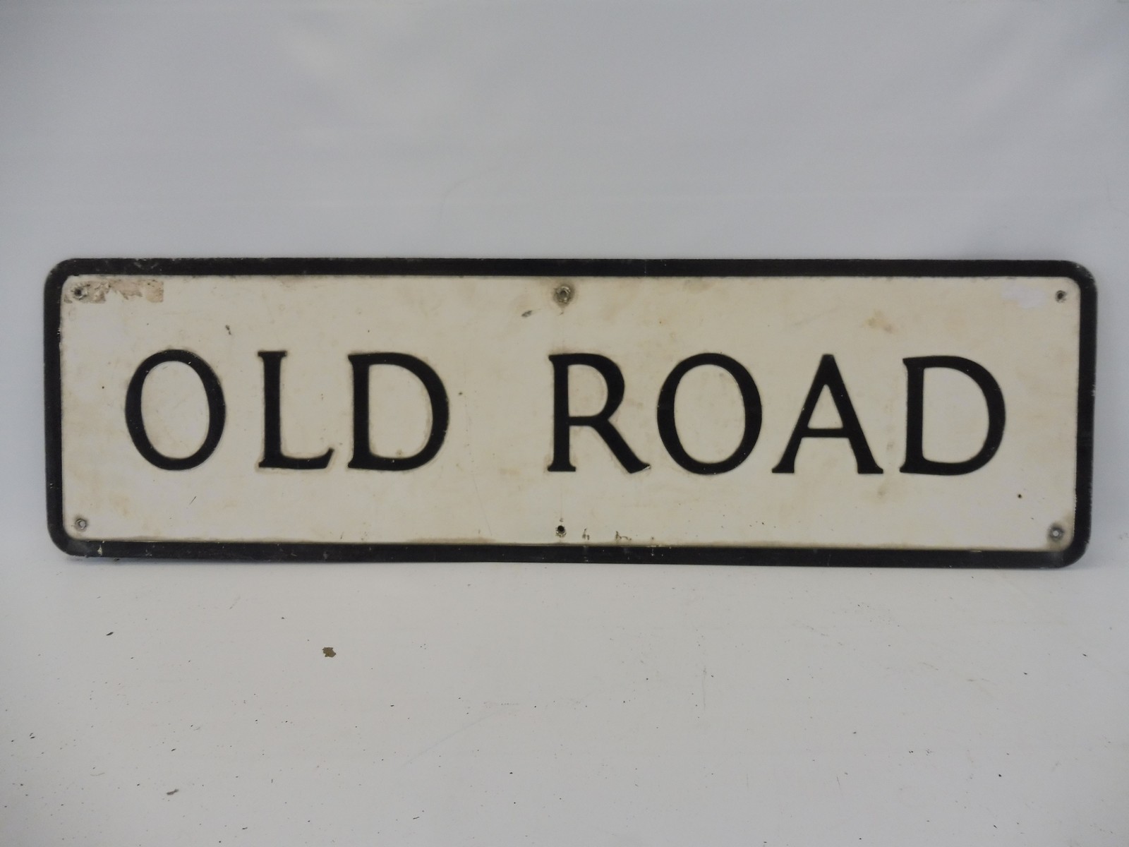 A pressed street sign 'Old Road', 31 x 9".
