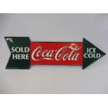 A Coca-Cola tin directional arrow dated 1990, 27 x 9".