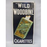 A reproduction 'Wild Woodbine' tin advertising sign, 14 1/2 x 29".