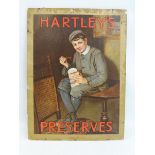 A Hartley's Preserves pictorial showcard depicting a boy sat on a table eating jam, with original
