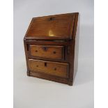 A miniature wooden bureau, 8 1/2" w x 10 1/2" h x 6" d.