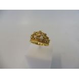 An unusual yellow metal, probably gold ring, ring in the form of a crown inset with small diamonds