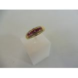 A 9ct gold ruby and diamond channel ring, weight approx. 2g.
