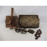 An 18th Century country house 'box' door lock and key, with ornate steel door plate on a dark