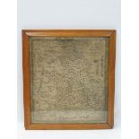 A fine Georgian map sampler extensively decorated with place names in a maple frame, 24 x 26 1/2".