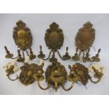 Four matching wall mounted brass three branch wall sconces, one with different drip trays, plus