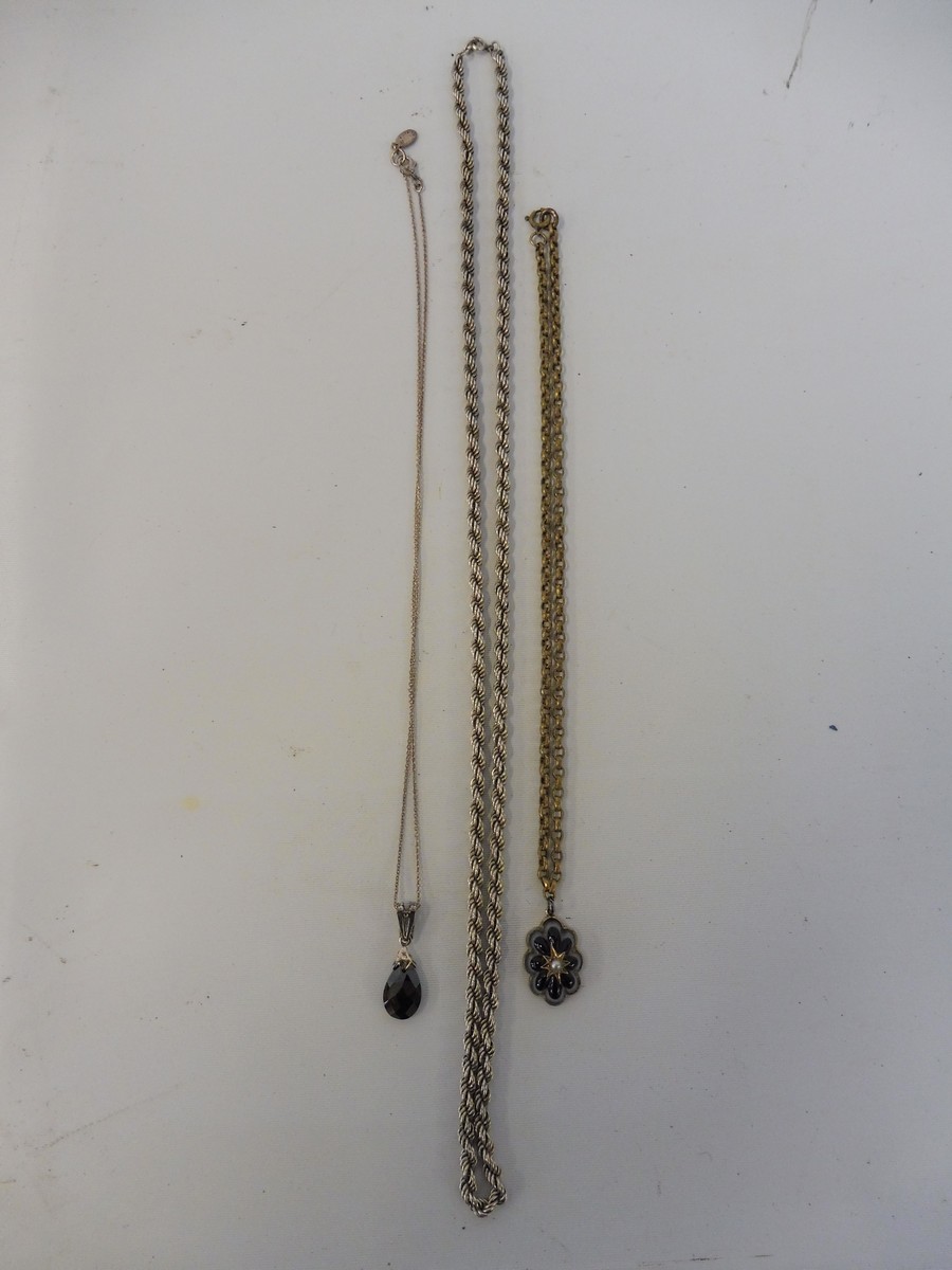 A heavy silver rope twist necklace, an unusual pendant possibly glass, set in yellow metal (probably