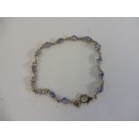 A silver bracelet set with tanzanite.