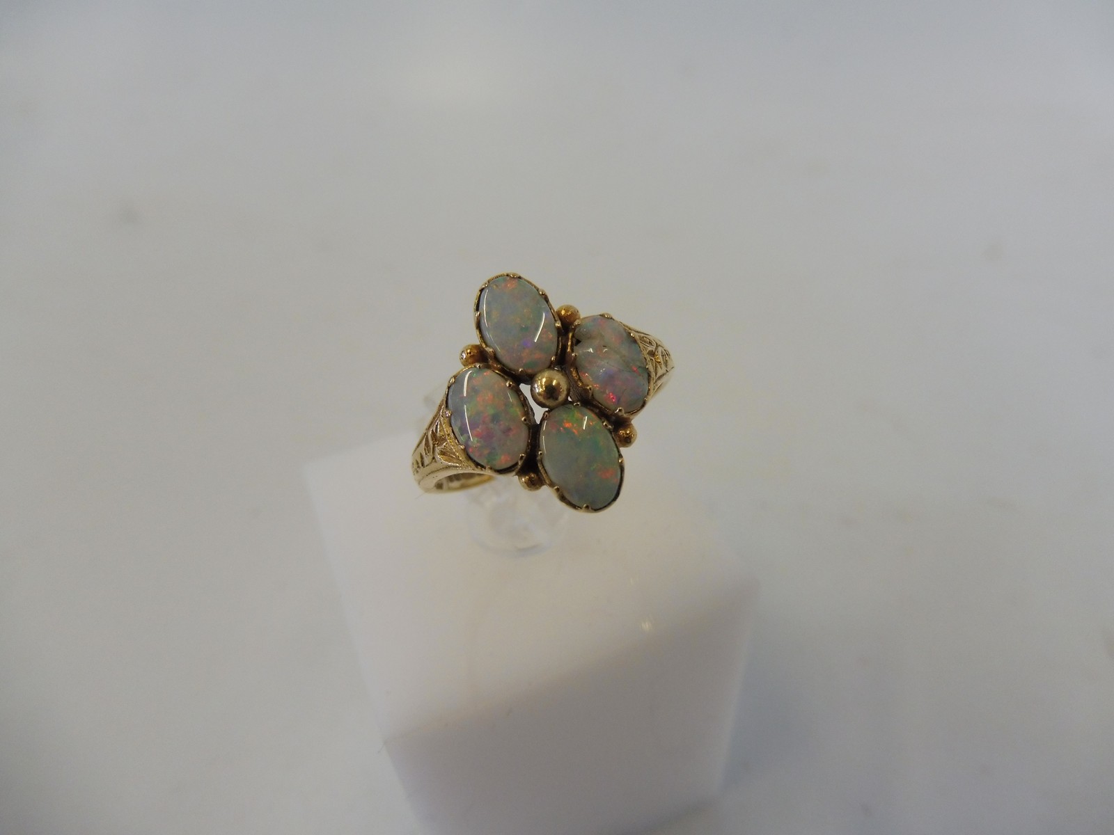 A 9ct gold and opal ring, one of the four stones is damaged, weight approx. 3g.