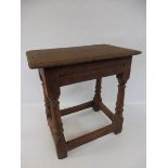 An 18th/19th Century red painted joined oak stool, the top 18 x 11 1/2", 18" h.