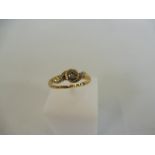 A 9ct gold ring set with a central diamond, weight approx. 2g.