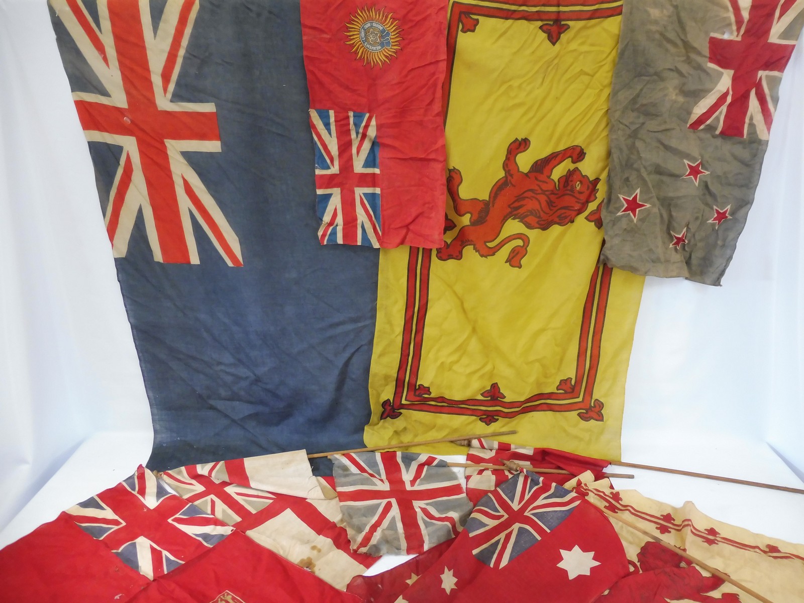 A selection of flags, some on poles possibly naval, various sizes.