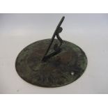 A patinated brass/bronze sundial, 7" diameter.