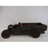 A folk art blue painted elm scratch built child's pull-along truck, approx. 33" long.