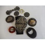A selection of unusual buckles and brooches including a pierced silver two piece nurse's buckle.