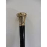 A silver topped ebonised walking cane, the knop with stylised decoration, London hallmark, date mark