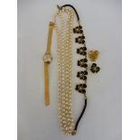 A long string of pearls, a lady's wristwatch and a decorative French necklace and matching