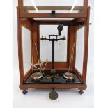 A laboratory chemical beam balance by Webb in a good quality hardwood and glass case, 15" w x 19"