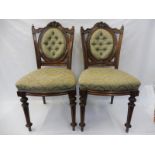 A pair of Victorian walnut upholstered salon chairs.