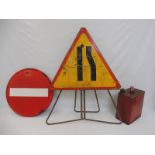 A triangular road sign, a circular No Entry road sign and a petrol can.