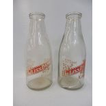 Two Liss Dairy glass milk bottles.