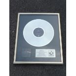 A record company platinum disc presented to Roger Walters of Pink Floyd, by Harvest Records to