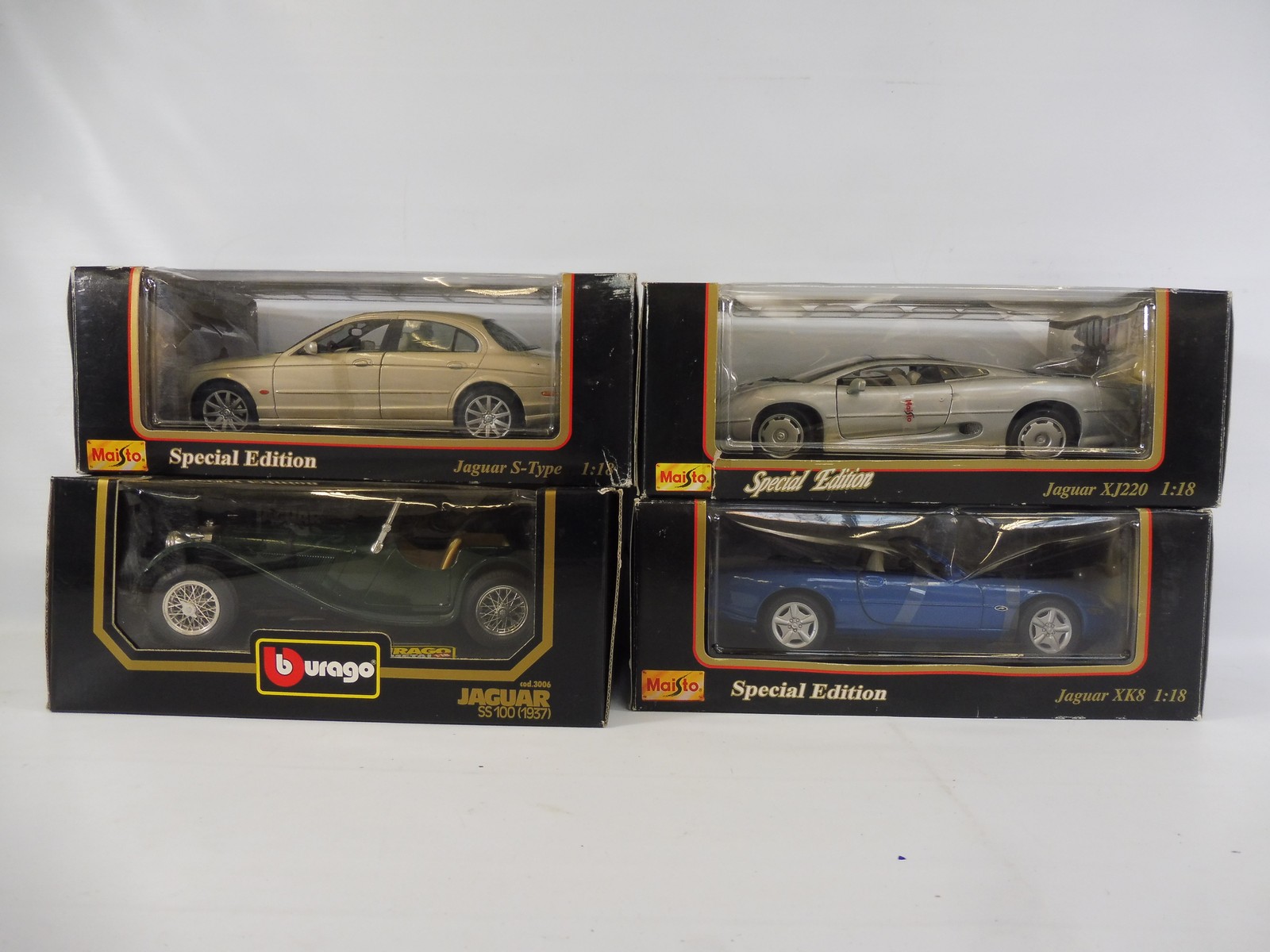 Four boxed Burago 1:18th scale models, boxes good, all Jaguars.