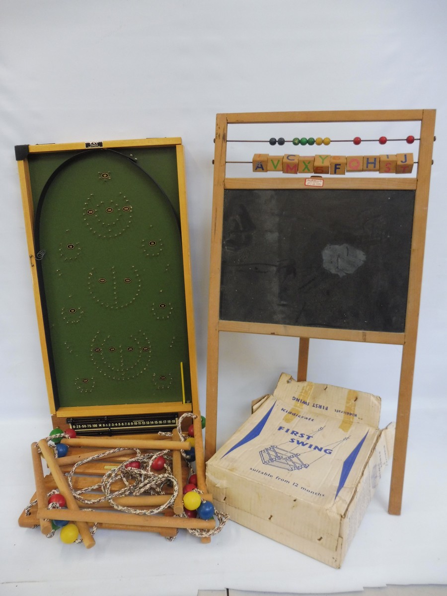 Three 1950s children's toys to include a blackboard, a swing and bagatelle.